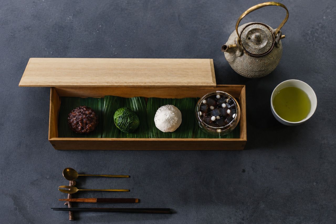 Three types of traditional Japanese sweets from SISIRI, a small anmitsu (a dessert with red bean paste and fruit), and a drink.
